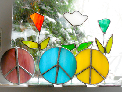Stained glass peace signs and flowers in window