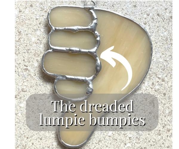Example of lumpy bumpy soldering on a stained glass hand with the thumbs down Mountain Woman Products