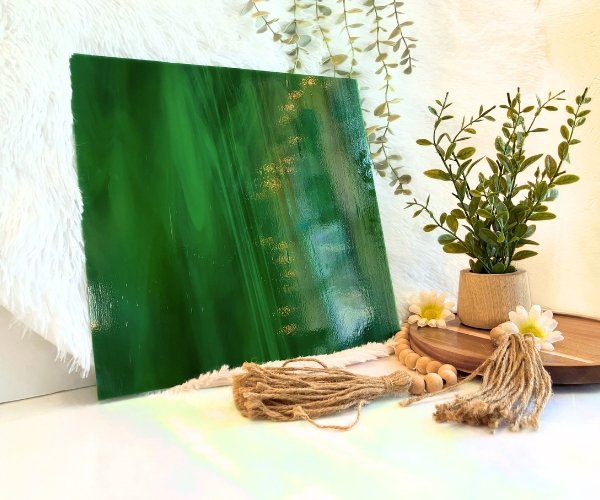 Oceanside Dark Green & White Opal stained glass sheet with wisps of white in dark green and a plant to the side in Mountain Woman Products studio 327-6S-F