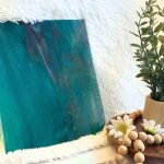 Wissmach Aqua Purple White Wispy stained glass sheet WO251 with a plant in Mountain Woman Products studio