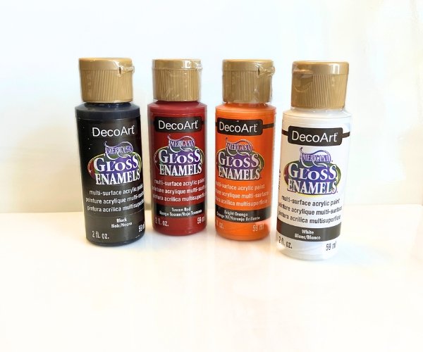 DecoArt Gloss Enamels Glass Paint for Stained Glass in Red Orange Black and White in front of white glass in the Mountain Woman Products Studio