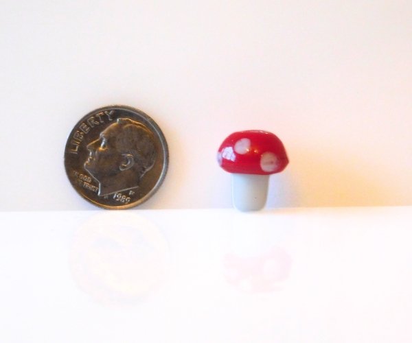 Lampwork glass mushroom bead in red and white with dime for size comparison Mountain Woman Products