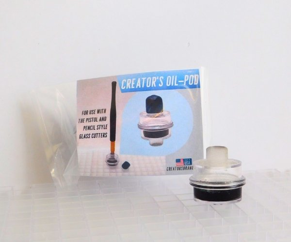 Creator's brand oil pod for stained glass with one in package and one out of it in a waffle grid Mountain Woman Products