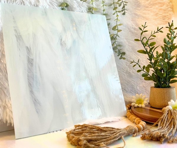 Oceanside Clear & White Wispy Stained Glass Sheet with white fur in the background and a plant and beads in the foreground Mountain Woman Products