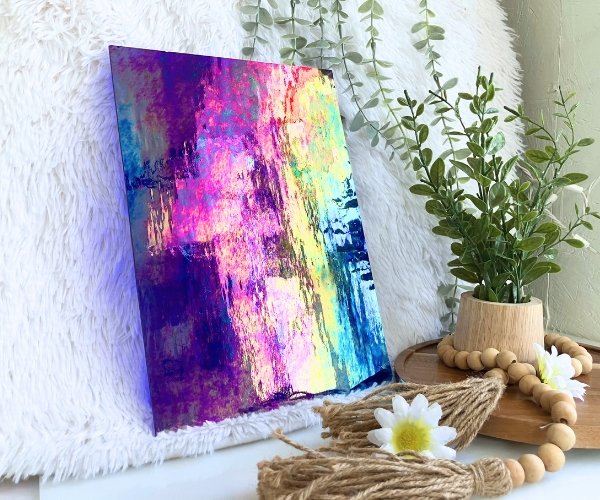 Wissmach Midnight Blue Transparent Luminescent 96-20 with pink yellow and aqua iridescence and a plant and daisies in the Mountain Woman Products studio