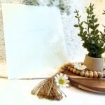 Designer Glass White Ice stained glass sheet with plant and daisy in background in Mountain Woman products studio
