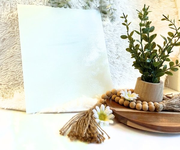 Designer Glass White Ice stained glass sheet with plant and daisy in background in Mountain Woman products studio