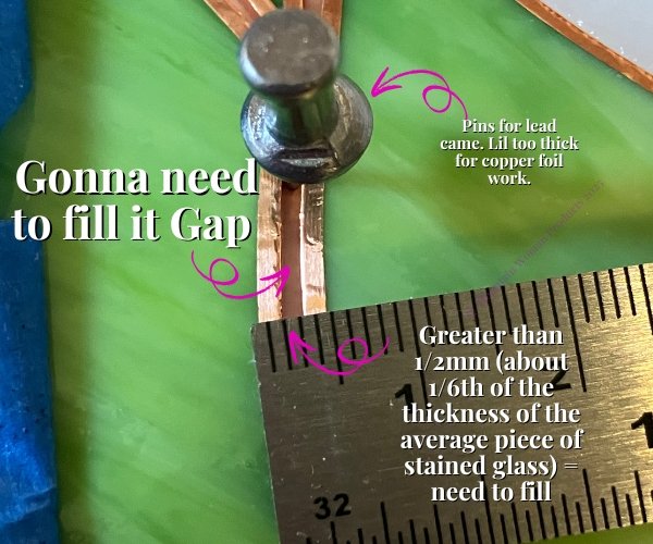 foiled stained glass pieces next to each other with a metal pin in between them showing too much thickness for a gap between pieces for soldering and a ruler with about 1 mm Mountain Woman Products