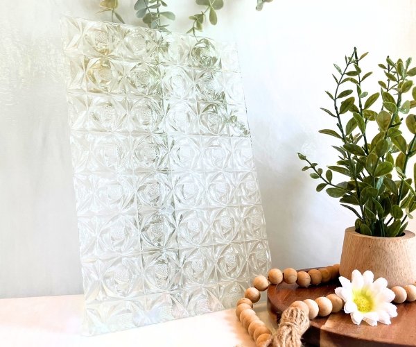 Kokomo KOG33WS Rosebud clear stained glass sheet with repeating rosebud raised patterns next to a plant and daisy in Mountain Woman Products Studio