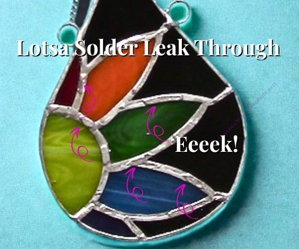 teardrop shaped stained glass piece with rainbow daisy inside showing solder that leaked through from the front to the back making lumpy bumps Mountain Woman Products