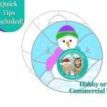 Snowman Stained Glass Pattern with snowman wearing a purple and green hat and a pink scarf in a circle background with blue sky and snowy hills Mountain Woman Products