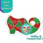 Christmas Elf Shoe Stained Glass Pattern with victorian style curled toe red and green shoe and Mountain Woman Products logo showing blonde girl with two braids and a santa hat and brown haired bearded buy with reindeer antlers