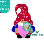 valentine's day heart gnome stained glass pattern with a red hat and pants blue shirt white beard holding a pink heart from the mountain woman products studio