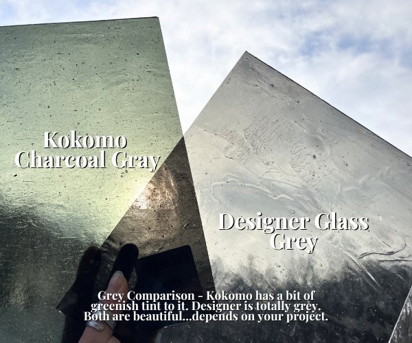 Designer Glass Grey Transparent Stained Glass Sheet vs a Kokomo Charcoal Grey glass sheet both transparent kokomo having a bit more of a greenish tint and designer being totally grey against a cloudy sky at the Mountain Woman Products studio