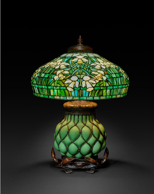 Tiffany Studios Stained Glass Daffodil Table Lamp with green mushroom shaped shade with white and yellow daffodils and a green base with aged bronze metalwork c.1910-1930 Courtesy Cleveland Museum of Art as shown in the Made In Glass Magazine article
