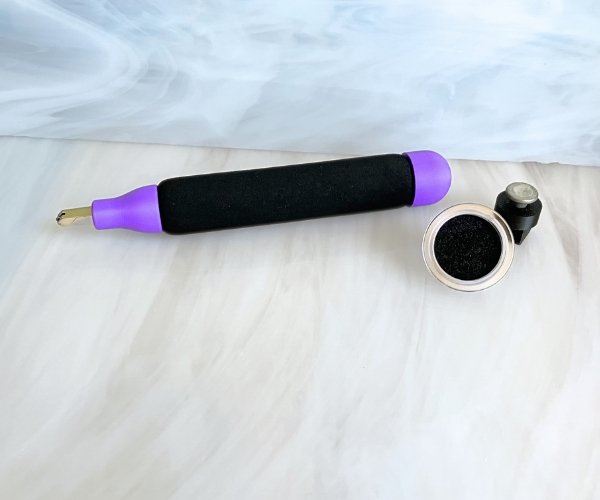 Creator's Cozy Cutter for Glass upright in purple and black with a magnetic base that fits in a waffle grid showing oil well too in the Mountain Woman Products studio