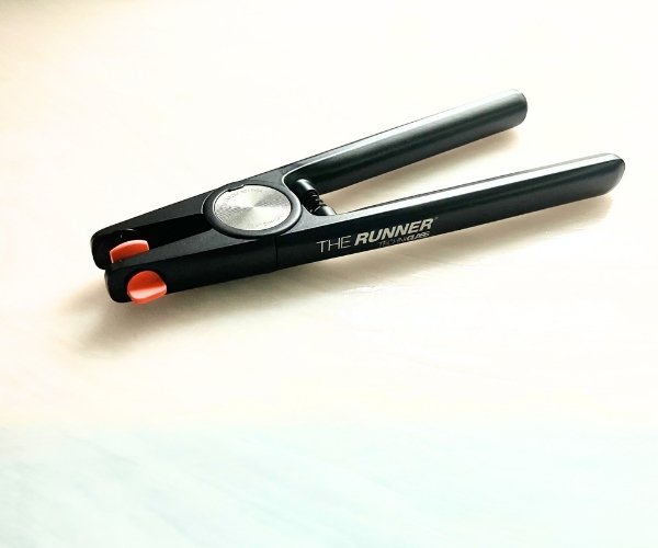 The Runner by Techniglass Running Pliers for stained glass showing black aluminum handles and body and orange adjustable top jaw in the Mountain Woman Products studio