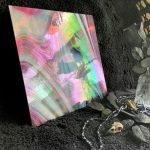 Oceanside Witching Hour Fuser's Reserve Special Edition Stained Glass Sheet red and white swirly opal and wispy glass with rainbow iridizing against a black background in the Mountain Woman Products studio