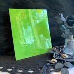 Designer Glass Apple Opal Fusible Stained Glass Sheet with a bright green like if alien barf were attractive and made into a sheet of glass in front of a black background at the mountain woman products studio DGF1732