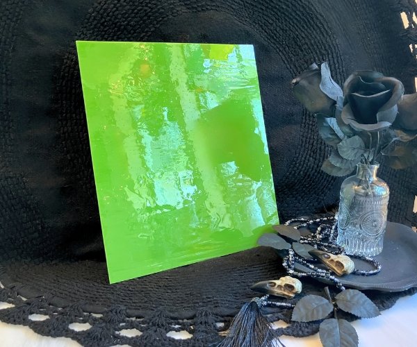 Designer Glass Apple Opal Fusible Stained Glass Sheet with a bright green like if alien barf were attractive and made into a sheet of glass in front of a black background at the mountain woman products studio DGF1732