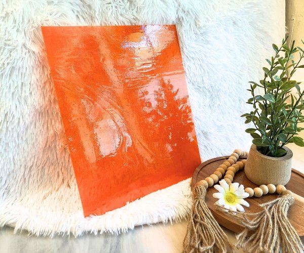 Designer Glass Dark Orange Transparent Fusible Glass with white background and plant in front at the mountain woman products studio