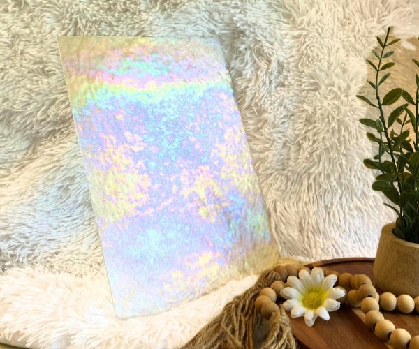 Wissmach Iridized Florentine Stained Glass Sheet on a white background with a plant & daisy in front at the mountain woman products