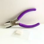 Nylon Straight Jaw Pliers for straightening wire with extra jaws and a purple handle in the mountain woman products studio